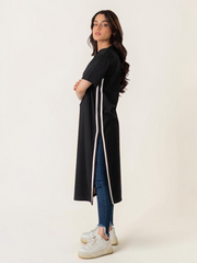 Full-length standing view of the Eve women's black maxi dress, showing its side opening, short sleeves and white contrast trim.