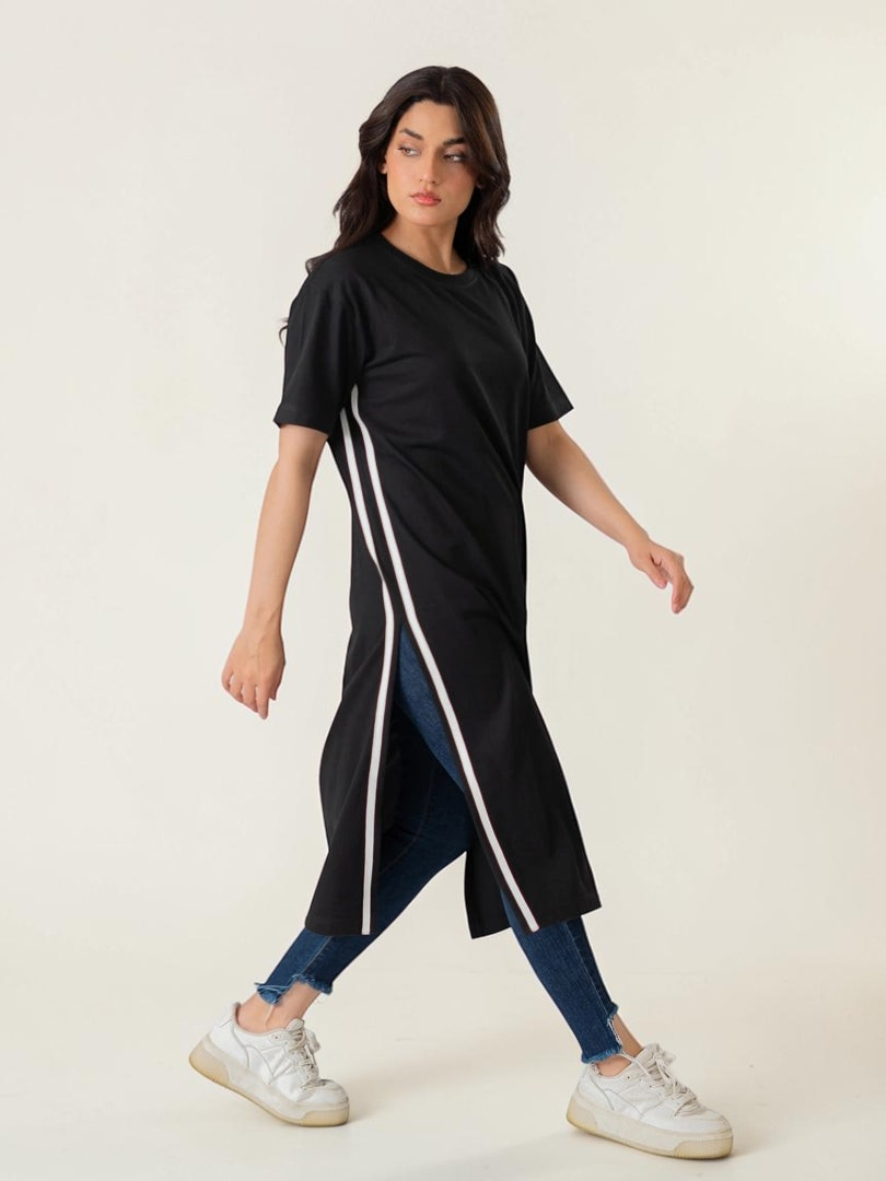 Model wearing Coastline's Eve Side Slit Maxi Dress in Black, featuring contrast tape detailing and a long side slit.
