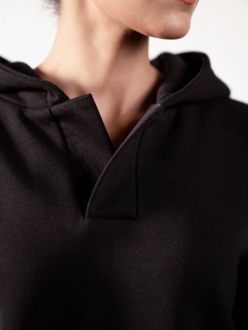 Close-up of the Garconne Black hoodie showing its double-layer hood and front neckline placket.