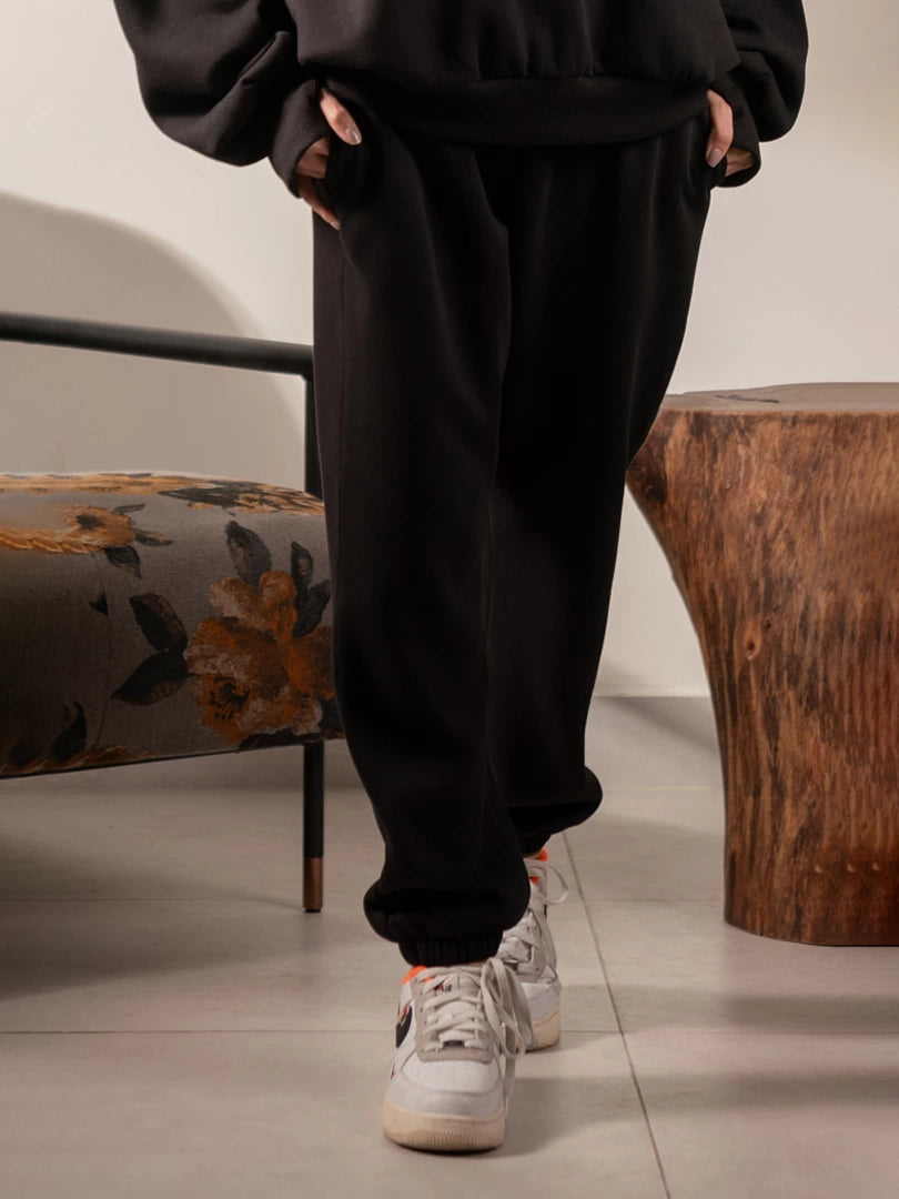 Closer view of the Garconne Black matching trousers, highlighting the relaxed fit and elasticated ankle cuffs.