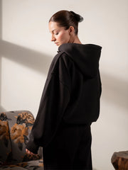 Side view of the Garconne Black matching set showing the oversized hoodie fit and cuffed trouser silhouette.
