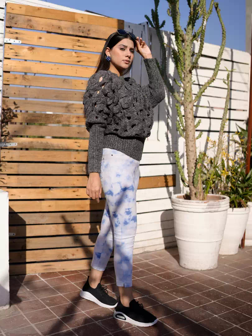 Model wearing Coastline's Giselle chunky sweater in Sparkling Gray with light blue tie-dye bottoms, standing in a full-body pose.