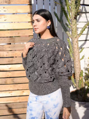 Side view of Coastline's Giselle chunky sweater in Sparkling Gray, showing the textured knit and fit.
