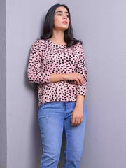Standing front view of the Animal Print Sweatshirt in Heather Pink, highlighting its all-over black spotted print and relaxed fit.
