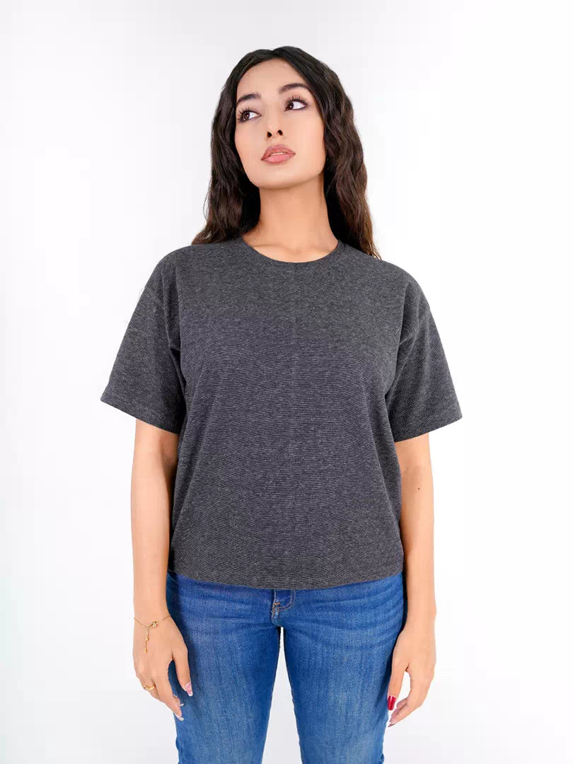 Model wearing Coastline's Heritage Fashion Tee in Pixel Grey, showing its textured fabric, crew neckline and relaxed short sleeves.