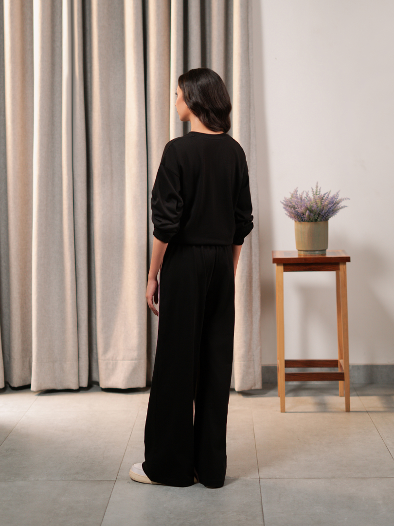 Back view of Indie Black co-ord set showing the relaxed top and wide-leg trouser silhouette