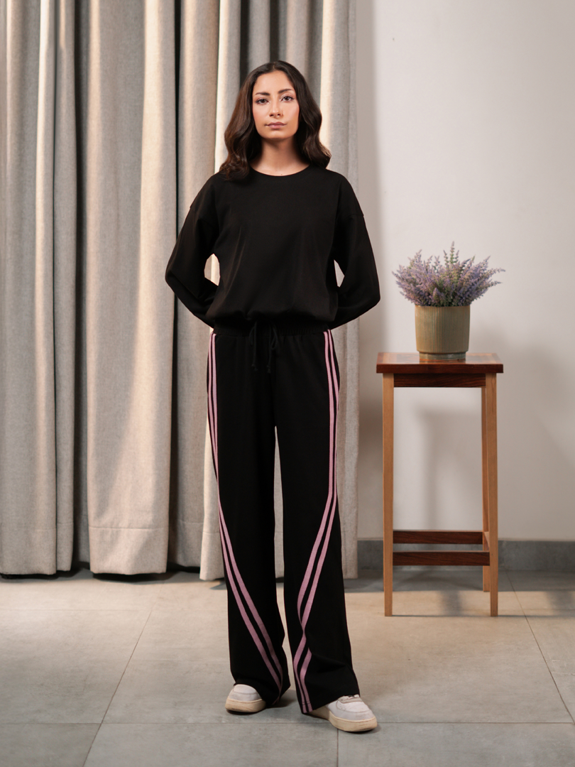 Full-length front view of Indie Black matching set featuring a relaxed top and contrast-striped wide-leg trousers