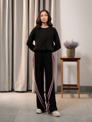Full-length front view of Indie Black matching set featuring a relaxed top and contrast-striped wide-leg trousers