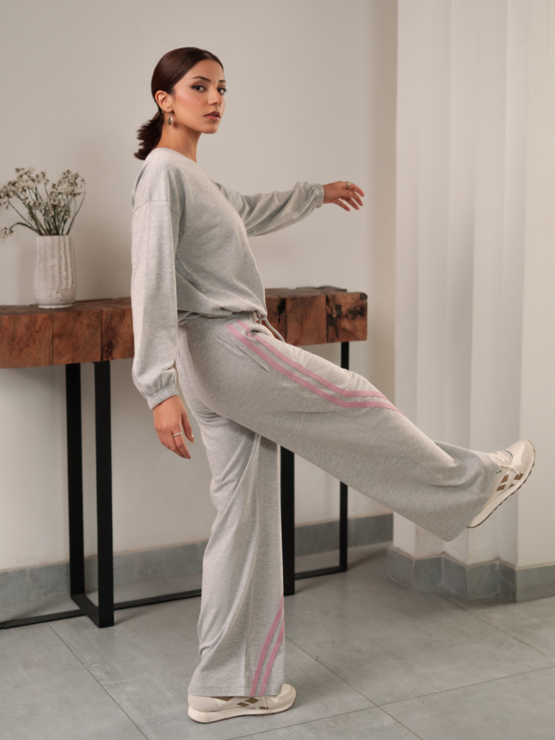 Side pose of Indie Heather Grey matching set showing the pink contrast stripes on the wide-leg trousers