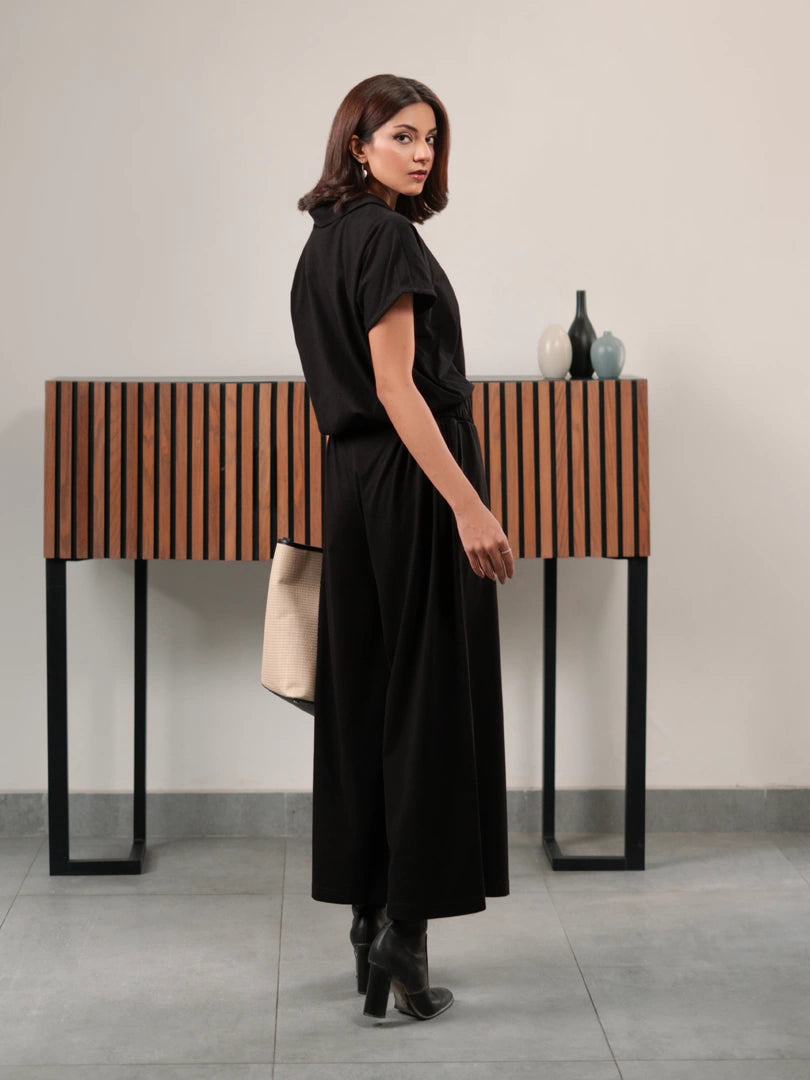 Full-length side view of the Jax Black summer matching set with a relaxed button-down shirt and wide-leg trousers.