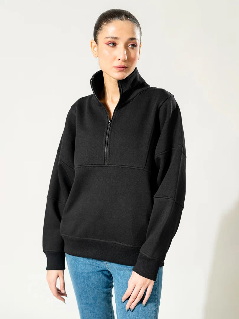 Front view of the Kai American black quarter-zip sweatshirt, showing its high collar, loose sleeves and ribbed hem.