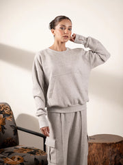 Model wearing the Kangroo Heather Grey cargo sweat set, showing the kangaroo-pocket sweatshirt and coordinating trousers.
