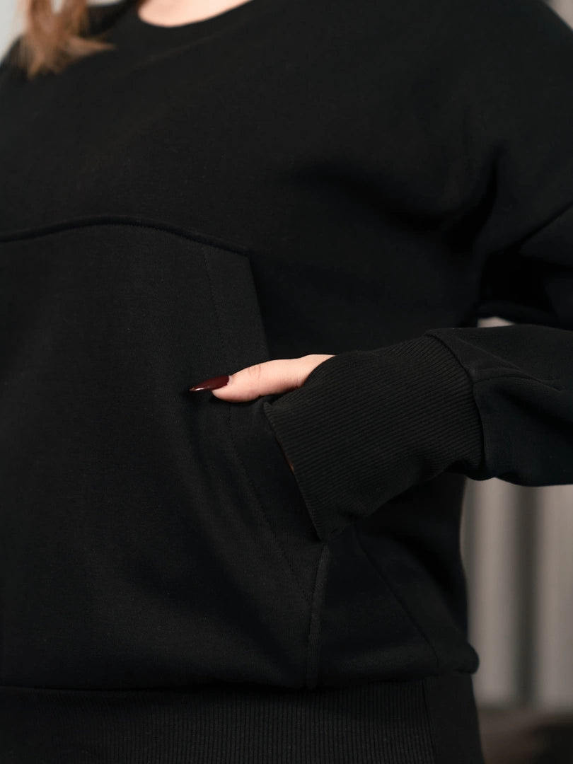 Close-up of the black Kangroo Matching Set showing a pocket detail on the outfit.