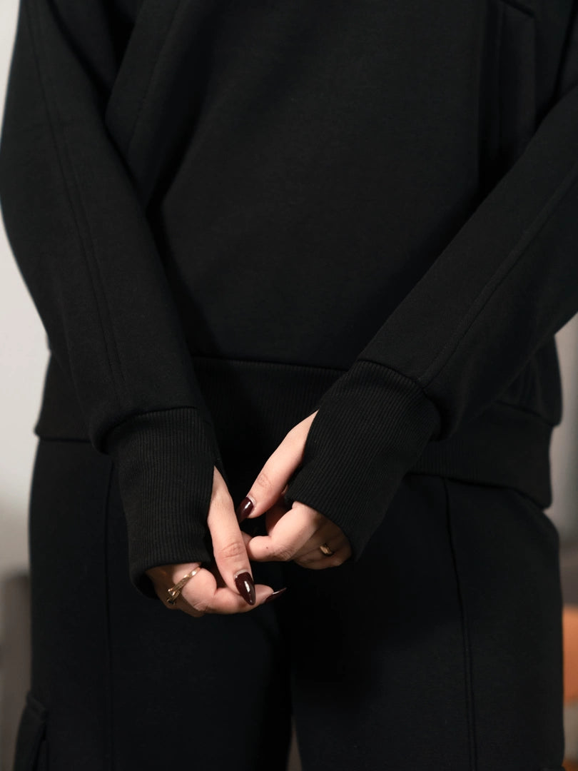 Three-quarter view of the black Kangroo Winter Matching Set worn with matching black trousers.