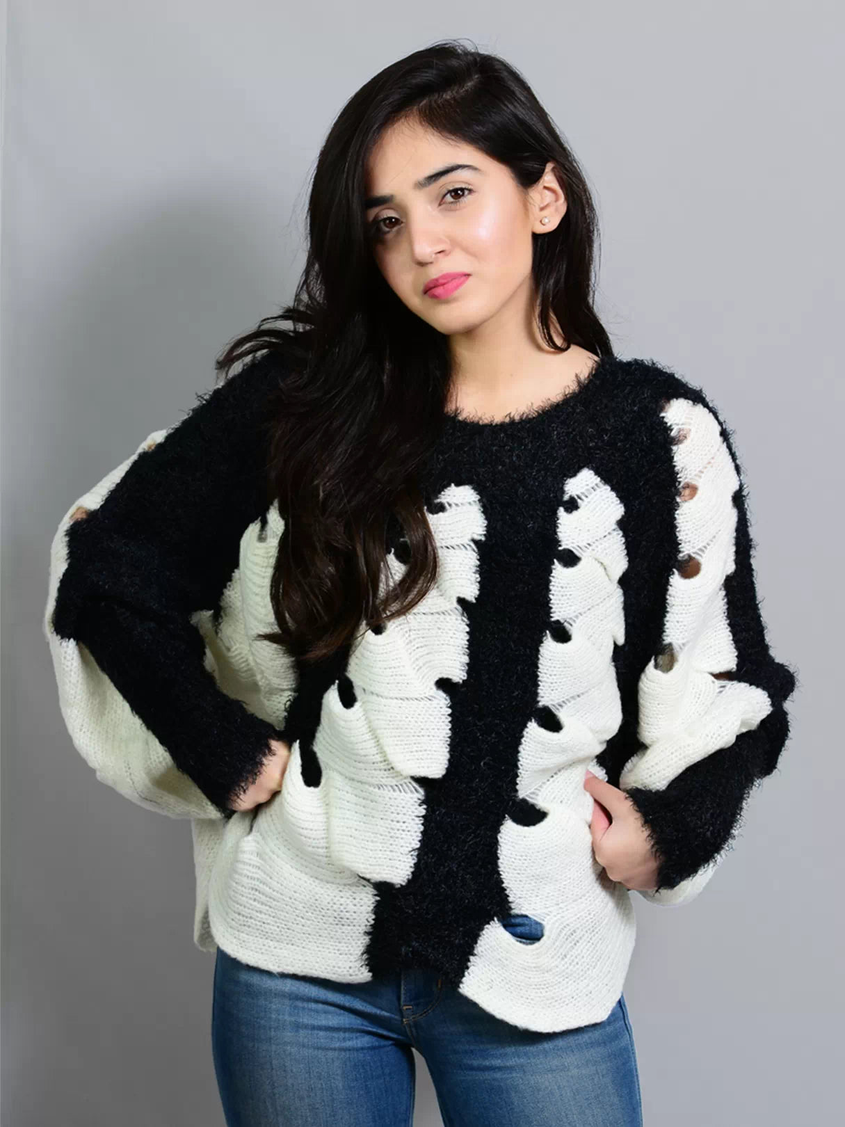 Closer portrait of a model wearing Coastline's Black and White Kate Fuzzy Sweater, highlighting its fuzzy knit texture.