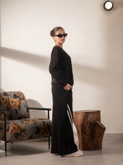 Side view of Lana Black sweat set showing the relaxed sweatshirt and contrast-striped wide-leg trousers