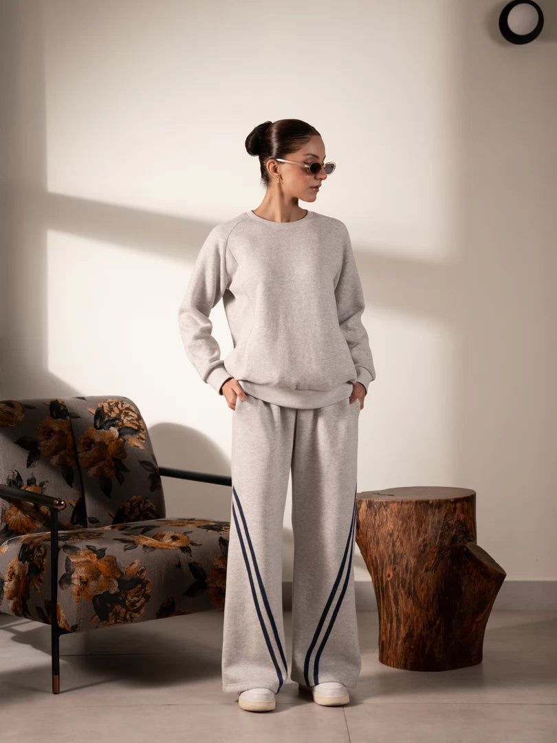 Lana Heather Grey striped sweat set for women featuring a long-sleeve sweatshirt and matching wide-leg trousers with contrast side stripes.