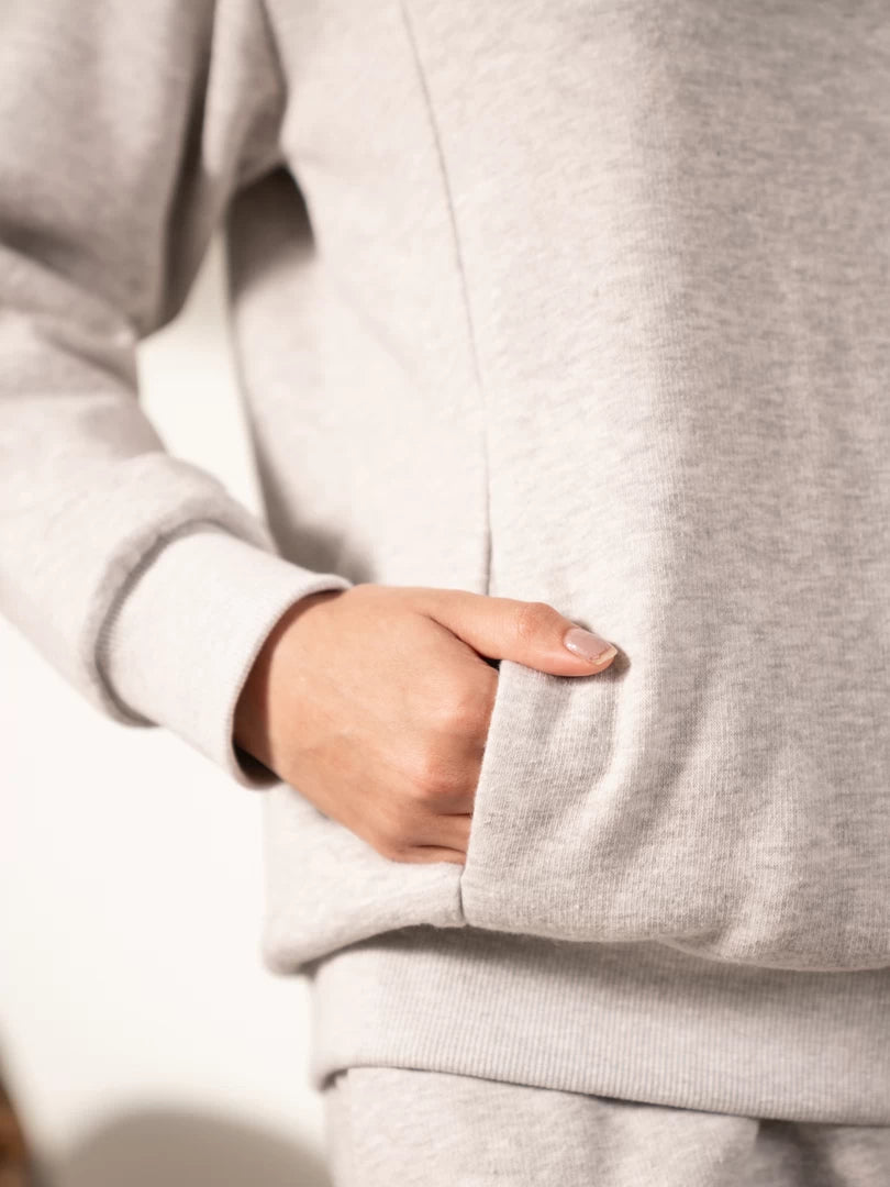 Close-up of the Lana Heather Grey sweatshirt highlighting the side pocket, fabric texture and stitching details.