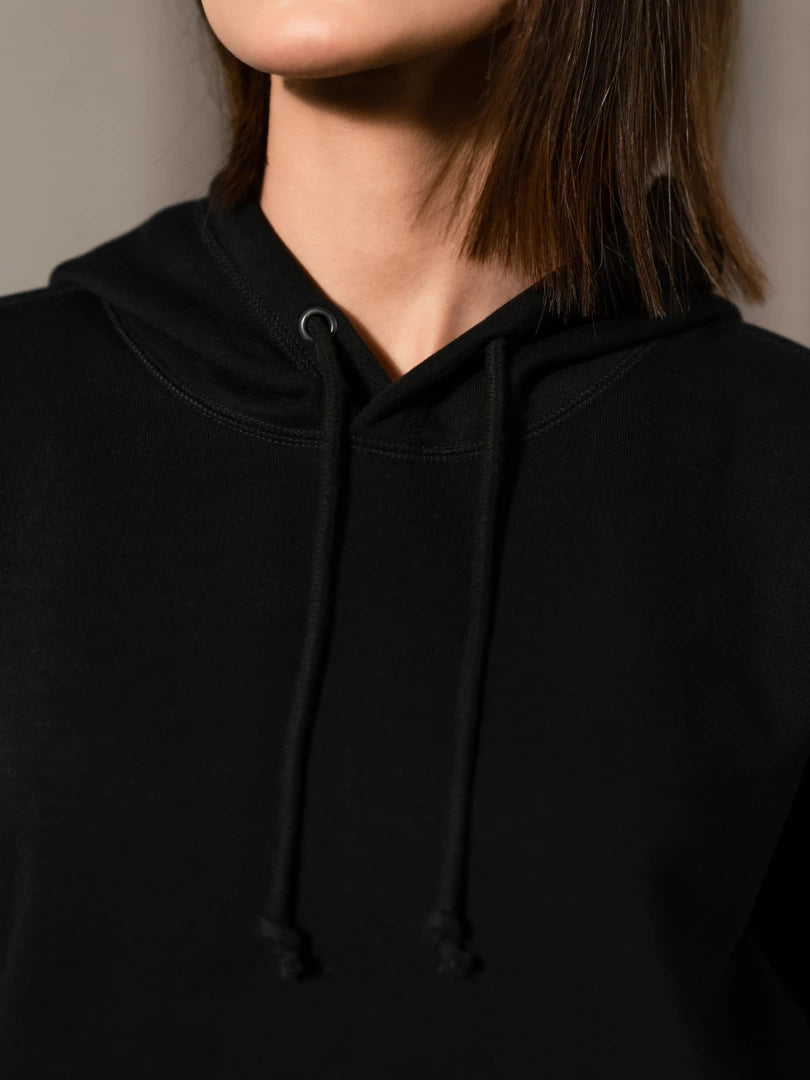 Close-up of the Lynn Essential Black hoodie's neckline, showing its drawstring hood and cotton fleece fabric.