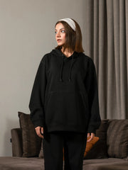Three-quarter view of the Lynn Essential women's Black hoodie, highlighting its roomy sleeves, hood and relaxed body.