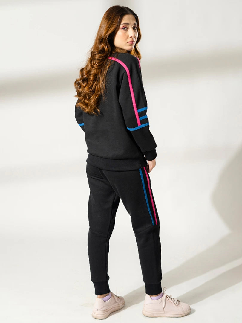 Back three-quarter view of the Michi Black athletic-inspired sweat set, showing the sweatshirt fit and matching trousers.