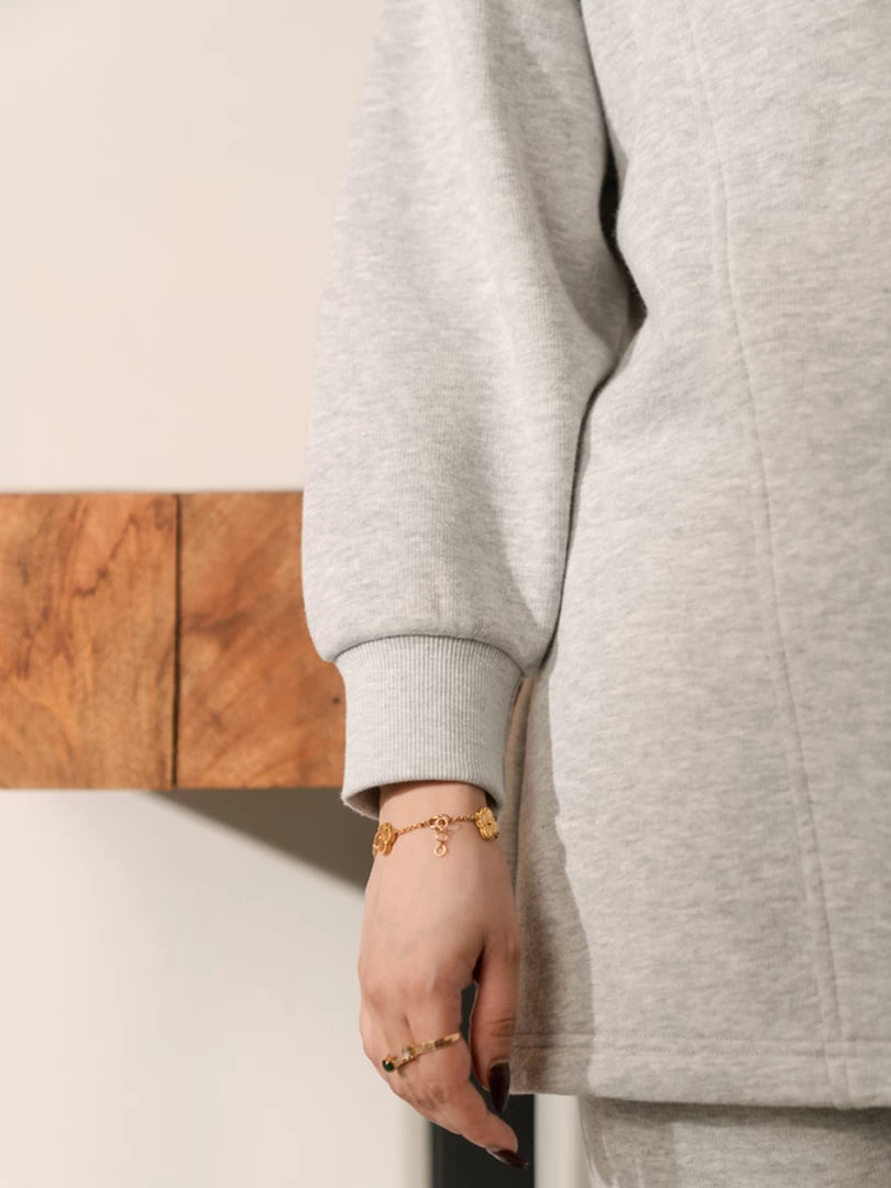 Close-up of the Nina Heather Grey fleece sweatshirt showing its ribbed sleeve cuff