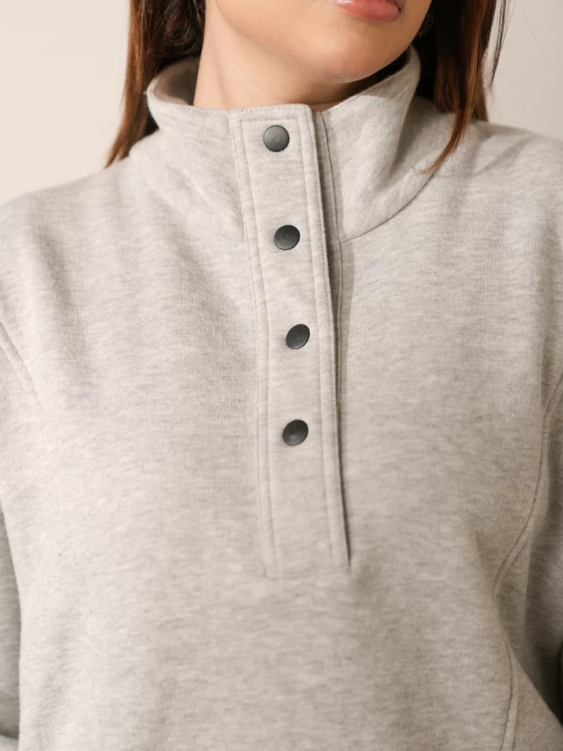 Close-up of Nina Heather Grey sweatshirt showing the stand-neck collar and snap-button closure
