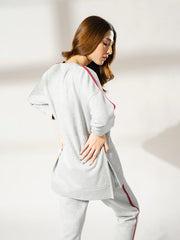 Rear three-quarter view of Ora Heather Grey athleisure sweatshirt showing its longer back hem and relaxed silhouette