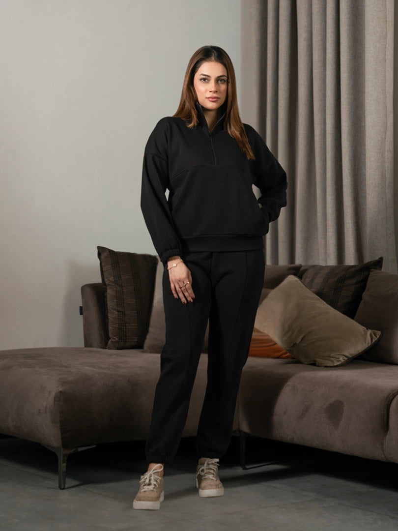 Ronin Black half-zip matching set for women, featuring a stand-neck sweatshirt and matching relaxed-fit trousers.