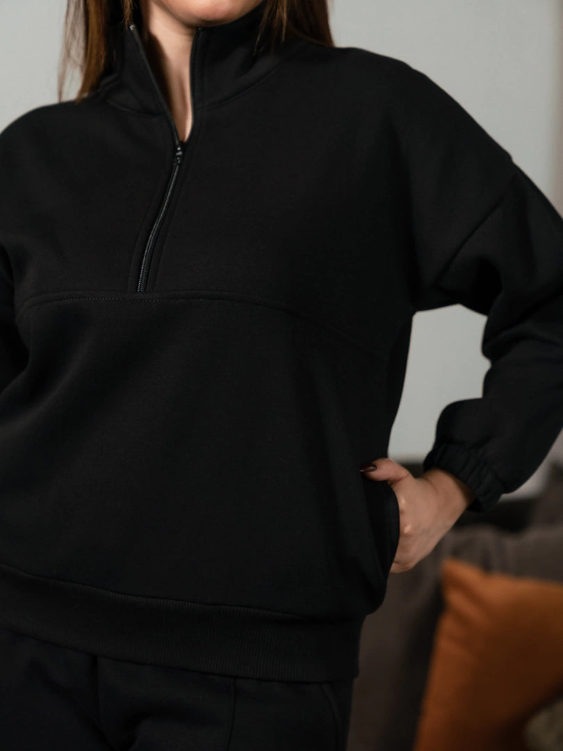 Closer front view of the Ronin Black sweatshirt showing its stand-neck collar, half-zip fastening and relaxed fit.