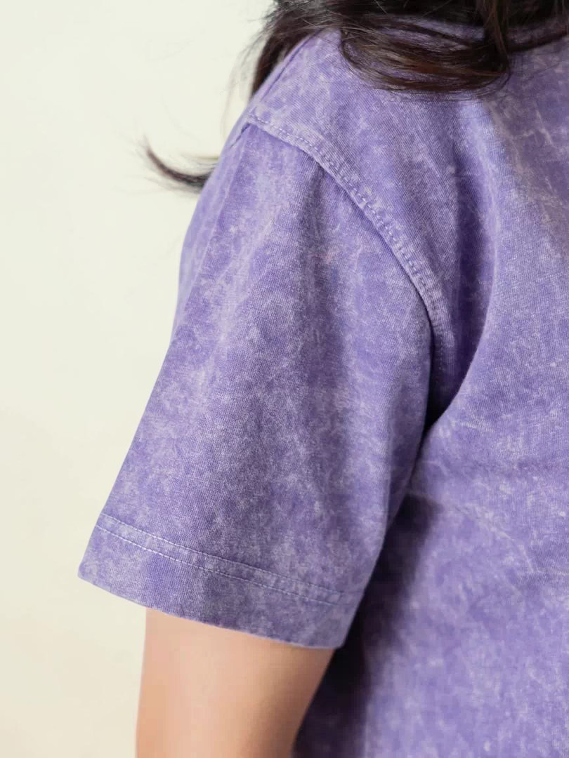 Close side view of Coastline's Sage Purple oversized cotton tee, showing the shoulder seam, short sleeve and mineral-washed texture.