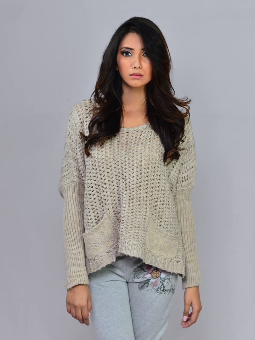 Model wearing Coastline's Sienna Chunky Sweater in Sand, showing the relaxed fit and textured knit design.
