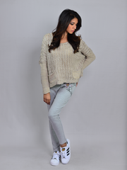 Full-length view of the Sienna Chunky Sweater in Sand styled with light blue jeans, showing its relaxed silhouette.