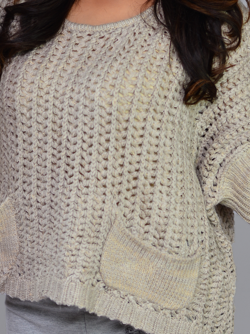 Close-up of the textured chunky knit fabric and stitching of Coastline's Sienna Sweater in Sand.