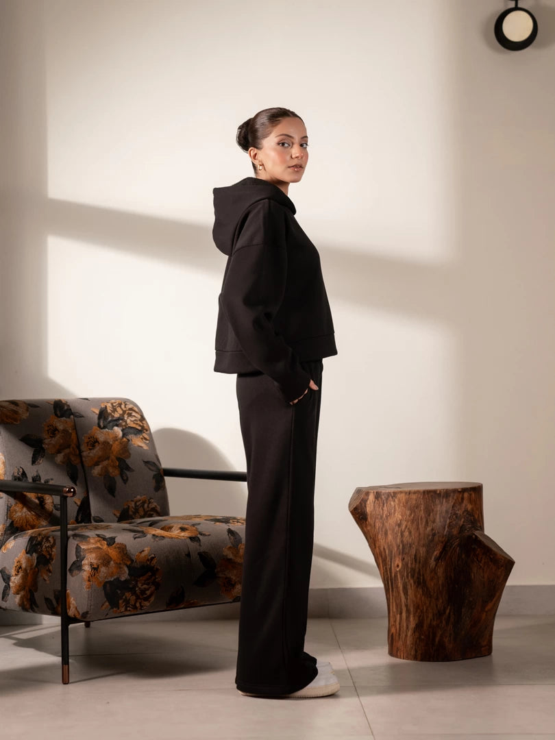 Side view of the Soho black matching set showing the hood, boxy top and wide-leg trousers.