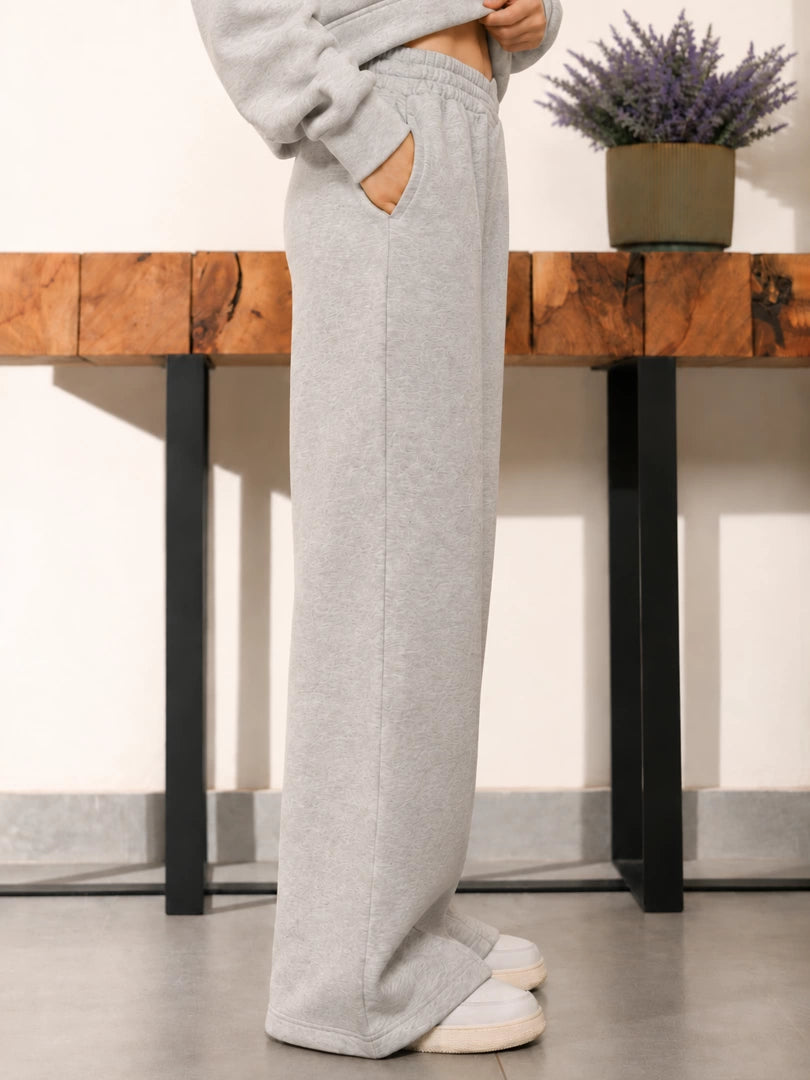 Angled view of the Soho Heather Grey trousers showing the relaxed wide-leg silhouette and fabric drape.