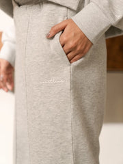Close-up of the Soho Heather Grey trouser pocket with the model placing one hand inside, showing the heathered fabric.