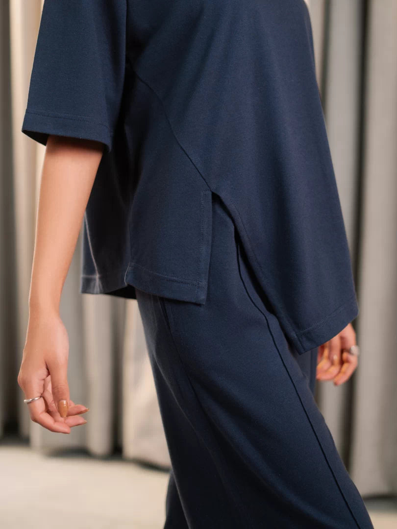 Close-up of the Sorelle Oxford Blue oversized top showing its side slit over the matching trousers.