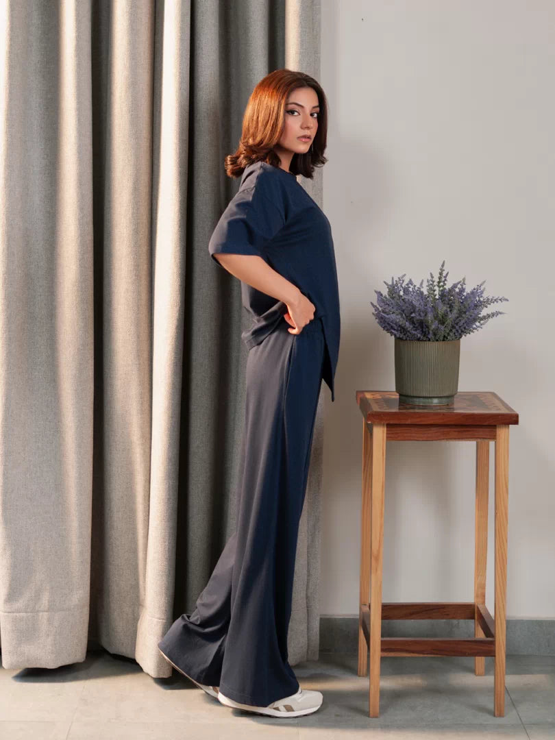 Full-length view of the Sorelle Oxford Blue two-piece co-ord set, with the model resting one hand on her hip.