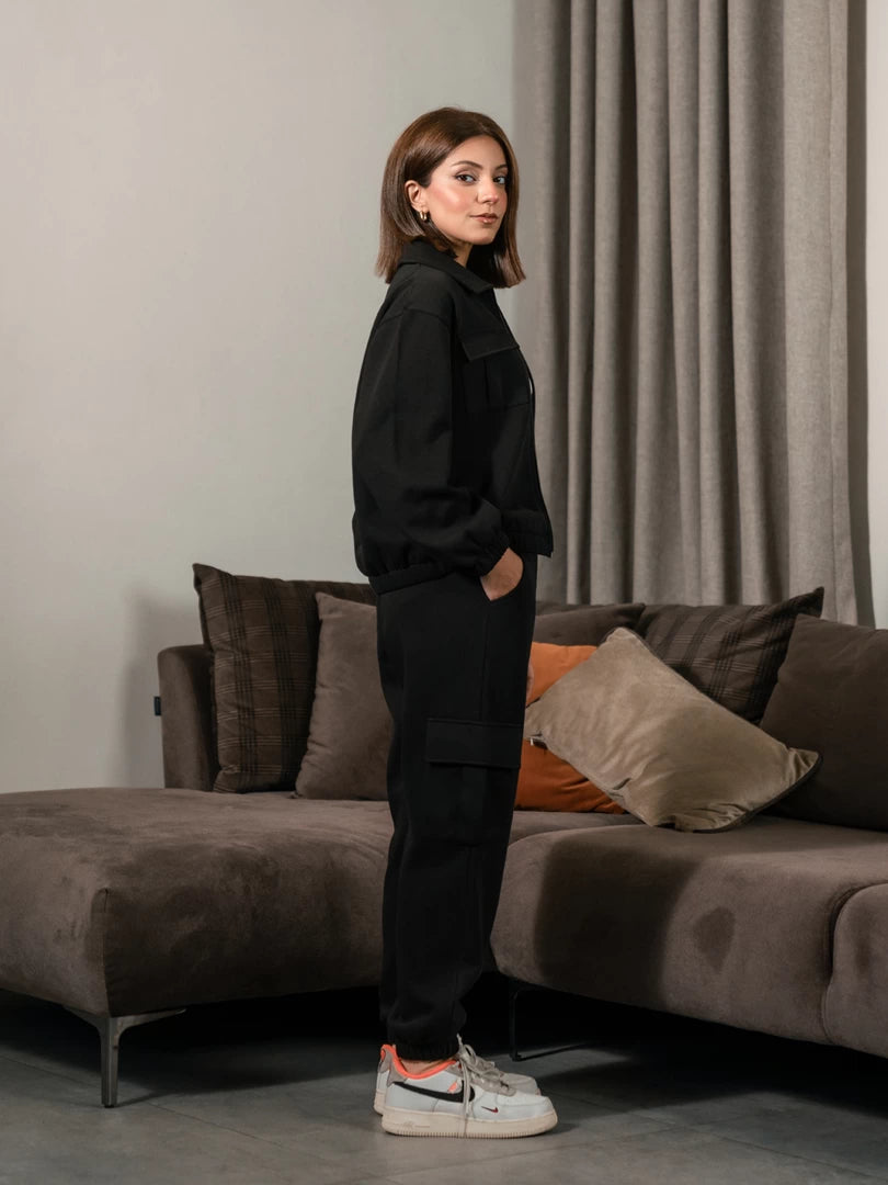 Side view of the Varley Black co-ord set with collared jacket and cargo trousers