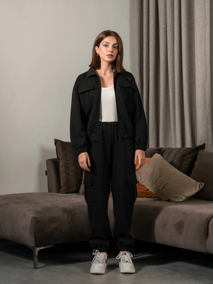 Varley Black women's matching set with collared zip-up jacket and cargo trousers front view