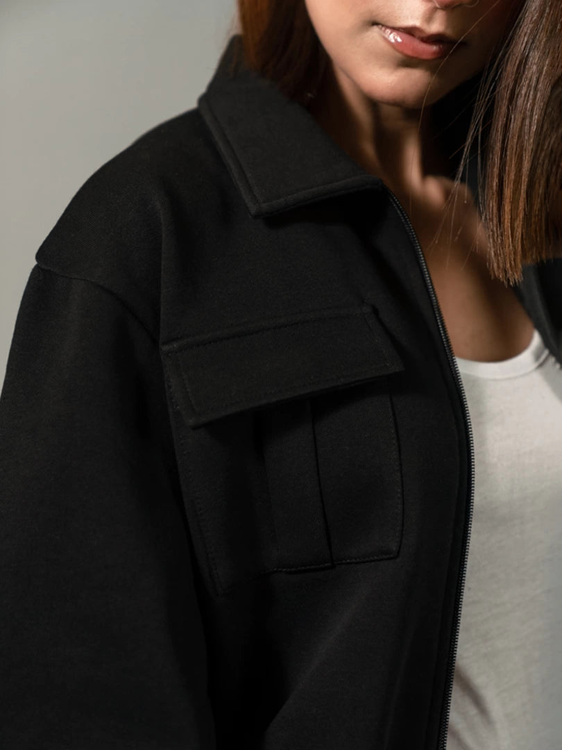 Close-up of the Varley Black jacket showing the collar and front zip-up detail
