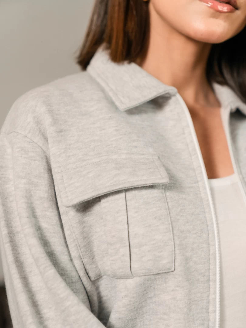 Close-up of the Varley Heather Grey jacket showing its structured collar and front flap pocket