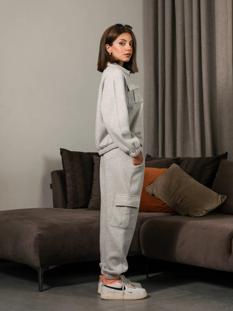 Side view of the Varley Heather Grey winter co-ord set showing the zip-up jacket and cargo trouser silhouette