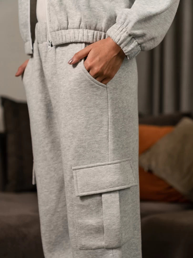 Close-up of Varley Heather Grey cargo trousers showing side pockets and flap pocket detailing