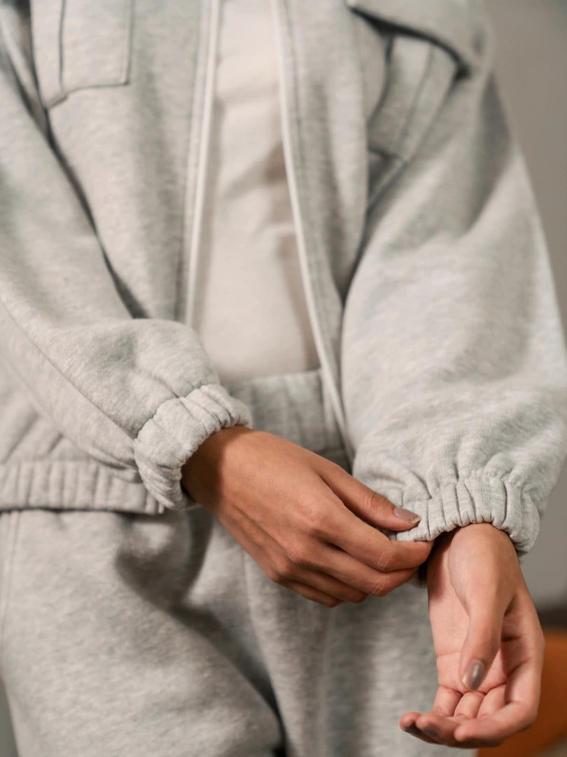 Detail view of the Varley Heather Grey zip-up jacket showing the sleeves, cuffs and front fastening