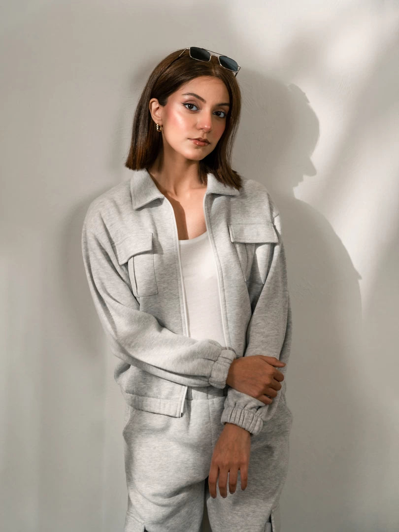 Closer view of the Varley Heather Grey zip-up jacket showing the collar, front opening and relaxed fit