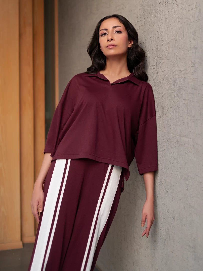 Angled view of Zane Mulberry co-ord set featuring a collared top and contrasting striped wide-leg trousers