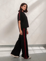 Zoey Black summer co-ord set for women with a relaxed short-sleeve top and wide-leg trousers featuring contrast red side stripes.