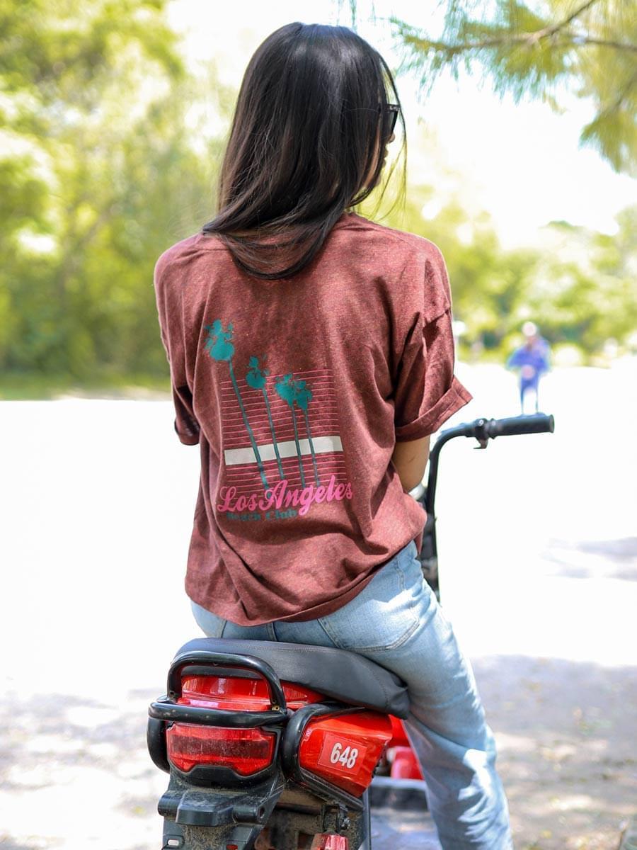 Back view of Coastline's Beach Club oversized graphic tee in Rosewood Red, showing its large printed back design and relaxed fit.